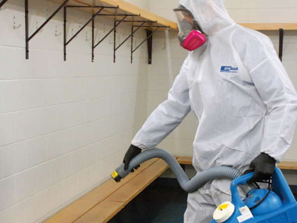 employee doing biohazard cleaning